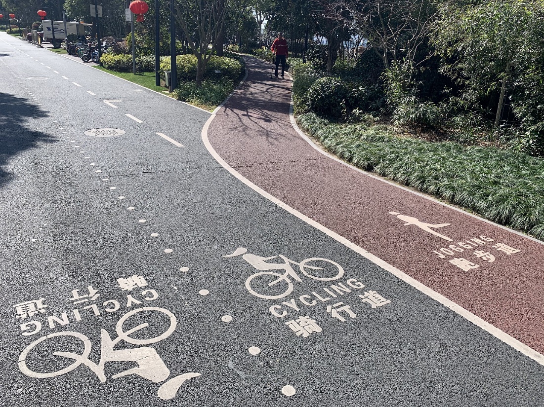 A person riding a bicycle on a road with writing on it

Description automatically generated with low confidence
